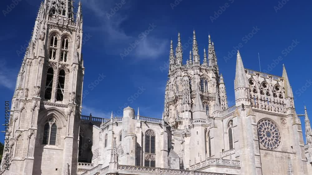 Burgos Cathedral facade against blue sky background. Spain. Slow Pan right Burgos Cathedral facade against blue sky background. Spain. Slow Pan right