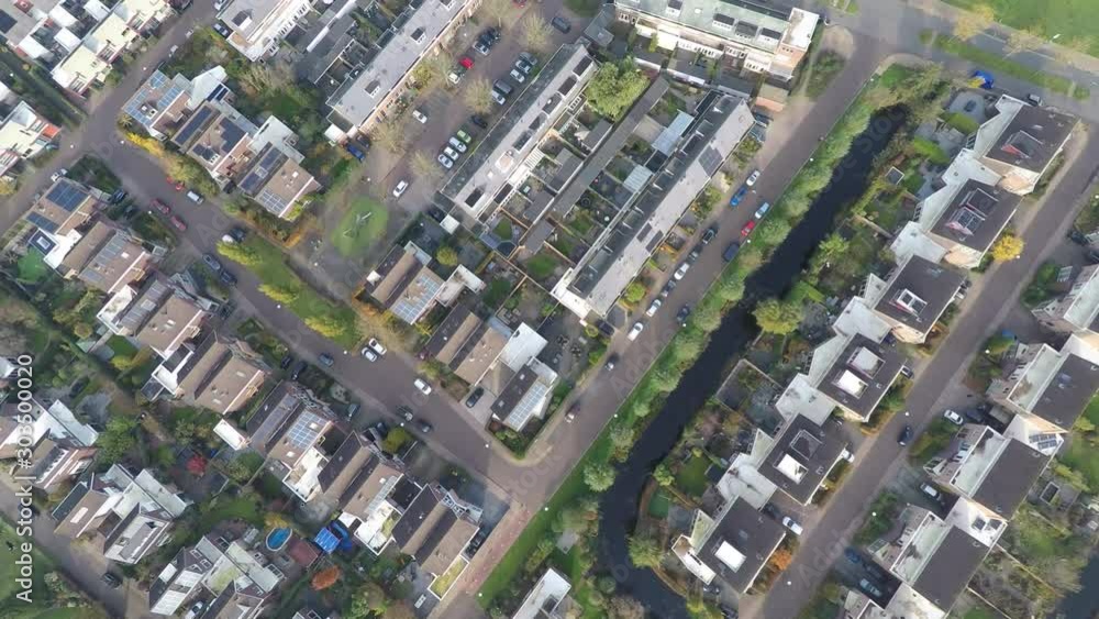 High top down aerial of suburban neighborhood with solar panels on rooftops High top down aerial of suburban neighborhood with solar panels on rooftops
