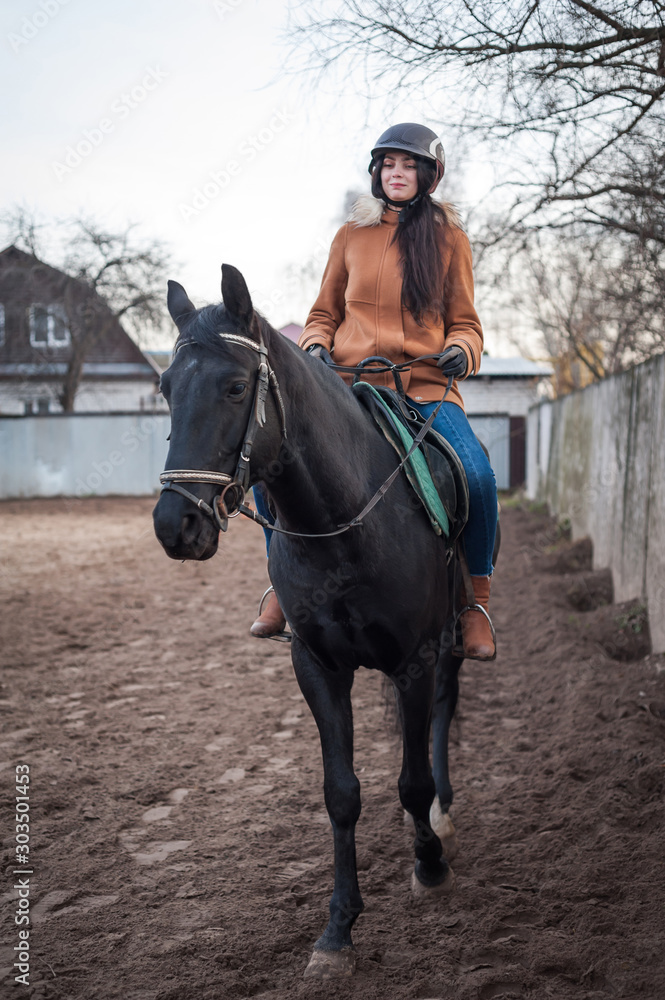 Fototapeta premium Training women and horses while walking on the racetrack.