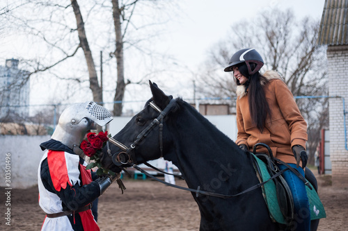 Medieval knight makes the offer of a lady on horseback.