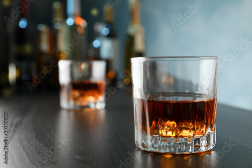 Glasses of whiskey on bar counter, close up