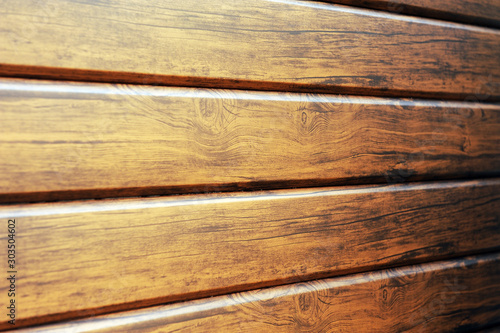 Metal lining on the facade of the building imitating the texture of wood.Element of the facade. Part of the facade decoration close-up. Facing material of buildings. Metal sheet roof.