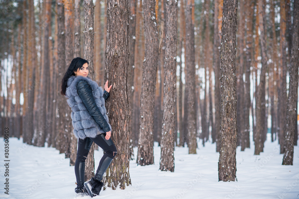 Naklejka premium Winter holidays concept. Arabic woman in stylish look at snowy day outside