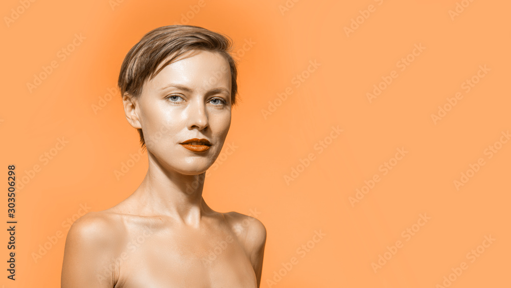 Image of young pure beautiful gentle woman standing naked isolated looking camera over orange color background. Spa, skincare and wellness Image of young pure beautiful gentle woman standing naked isolated looking camera over orange color background. Spa, skincare and wellness