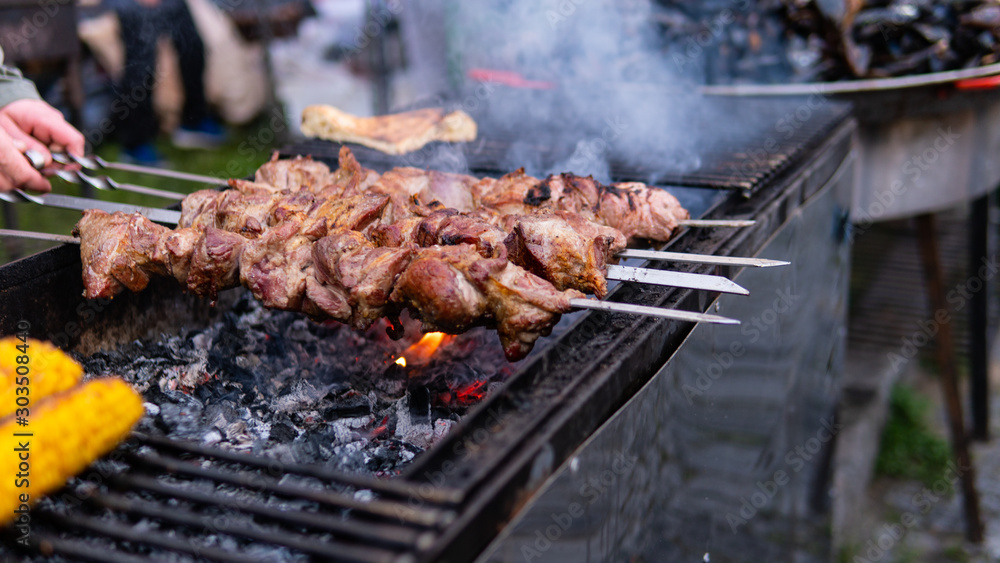 closeup of some meat skewers being grilled in a barbecue