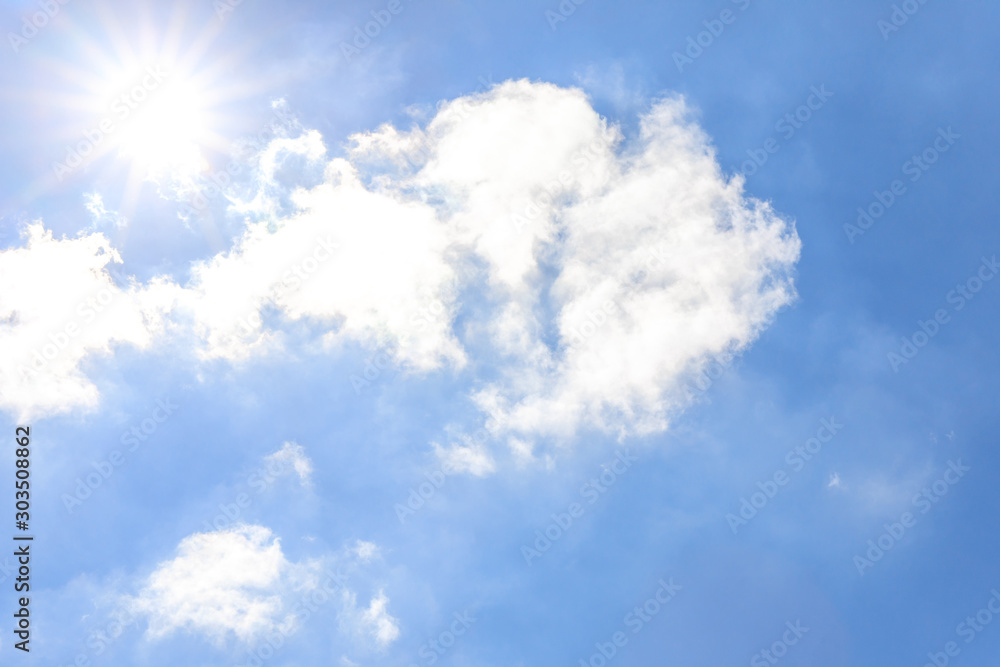 Clouds and blue sky with sunlight sunbeams or sunrays.