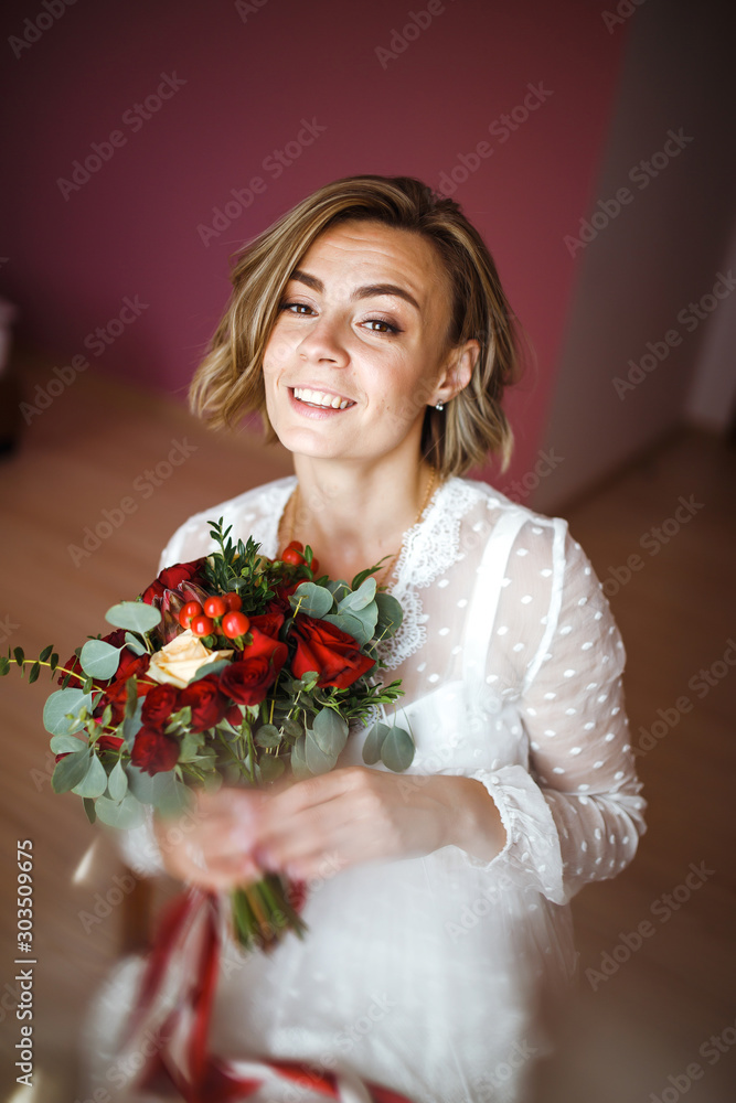 Beautiful bride with wedding flowers bouquet in white luxury dress is getting ready for wedding. Morning preparations. Bride with wedding makeup and hairstyle. Wedding day. Marriage. Beautiful bride with wedding flowers bouquet in white luxury dress is getting ready for wedding. Morning preparations. Bride with wedding makeup and hairstyle. Wedding day. Marriage.
