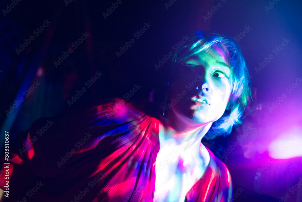 Psychedelic portrait of a girl with multi-colored lights.