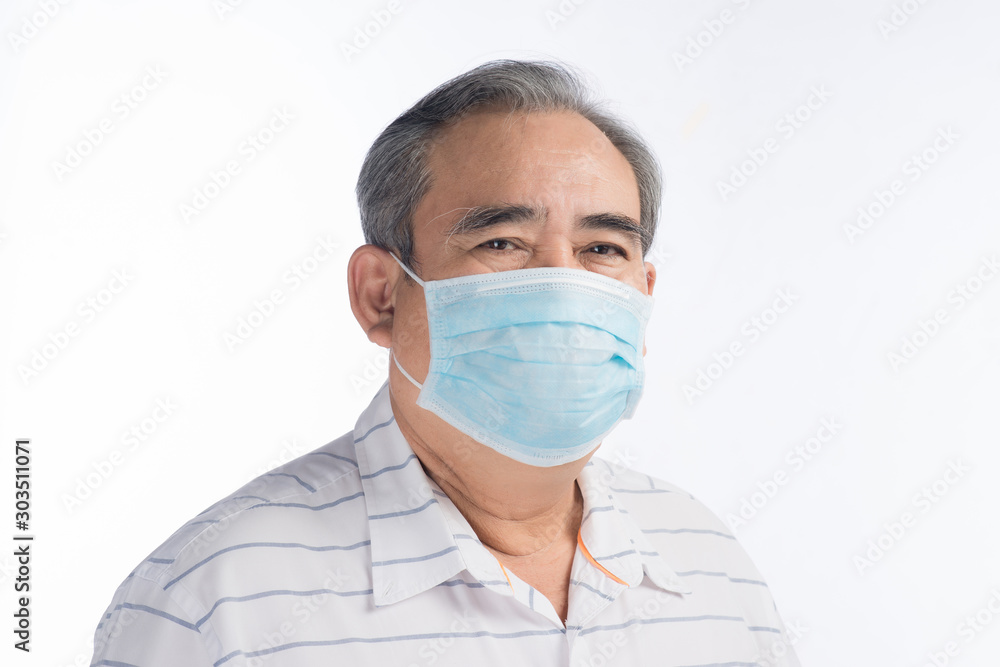 Asian senior man wearing face mask isolated on white background, selective focus. Asian senior man wearing face mask isolated on white background, selective focus.