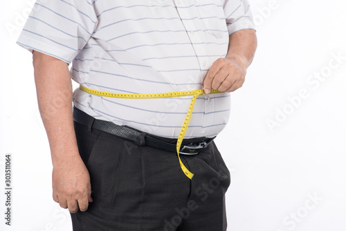 Fat mature man measuring his belly with measurement tape, isolated on white background