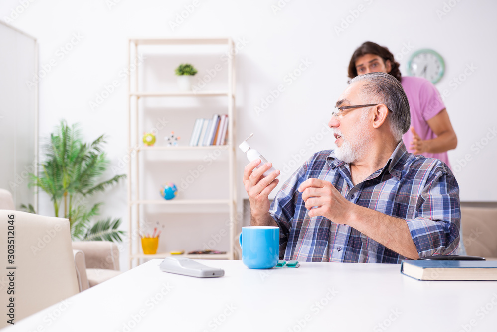 Young student and his old grandpa at home Young student and his old grandpa at home
