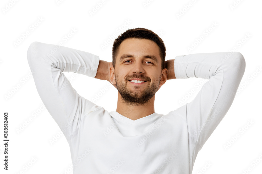 portrait of smiling handsome bearded man with arms behind the head in white shirt looking at camera isolated on white background. man taking rest portrait of smiling handsome bearded man with arms behind the head in white shirt looking at camera isolated on white background. man taking rest