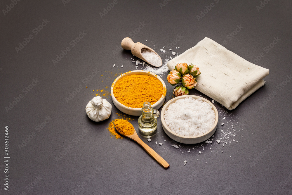 Personal care with natural ingredients. Healthy spa concept. Turmeric, sea salt, oil, towel. Stone concrete background Personal care with natural ingredients. Healthy spa concept. Turmeric, sea salt, oil, towel. Stone concrete background