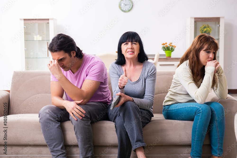Young family and mother-in-law in family issues concept Young family and mother-in-law in family issues concept