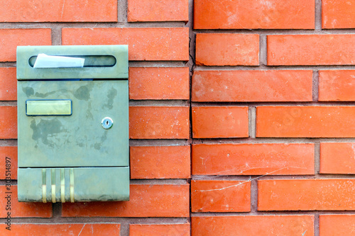 A beautiful mailbox hangs waiting for newspapers, parcels and letters.