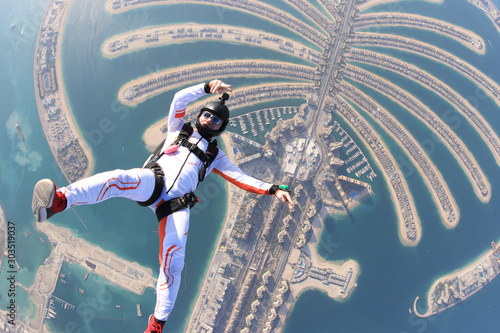 Dubai.People lies on Dubai Palm in free fall. Outdoor skydiving. Free fall on speed 200km/h 