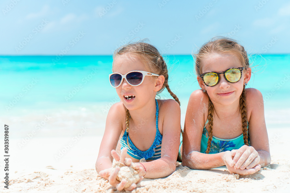 Portrait of two beautiful kids looking at camera background of beautiful nature of blue sky and turquoise sea Portrait of two beautiful kids looking at camera background of beautiful nature of blue sky and turquoise sea