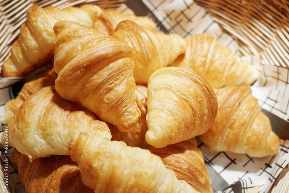 Many delicious mini croissants in the wicker basket. Many delicious mini croissants in the wicker basket.
