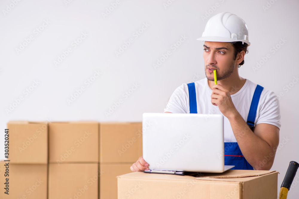 Young male professional mover doing home relocation Young male professional mover doing home relocation