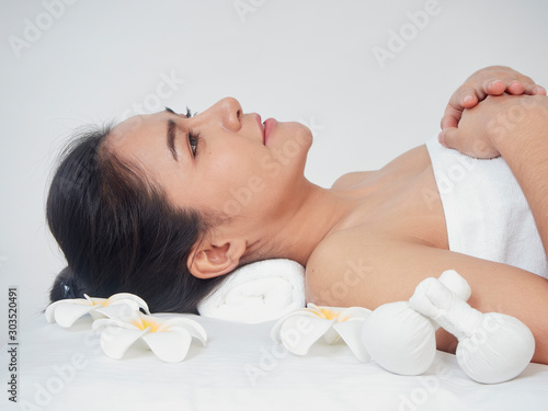 Young woman and spa accessories on massage table