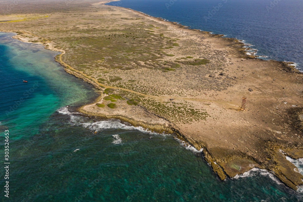 Aerial view of coast of Curaçao in the Caribbean Sea with turquoise water, cliff, beach and beautiful coral reef around Eastpoint