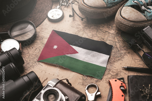 Jordan Flag Between Traveler's Accessories on Old Vintage Map. Tourist Destination Concept.