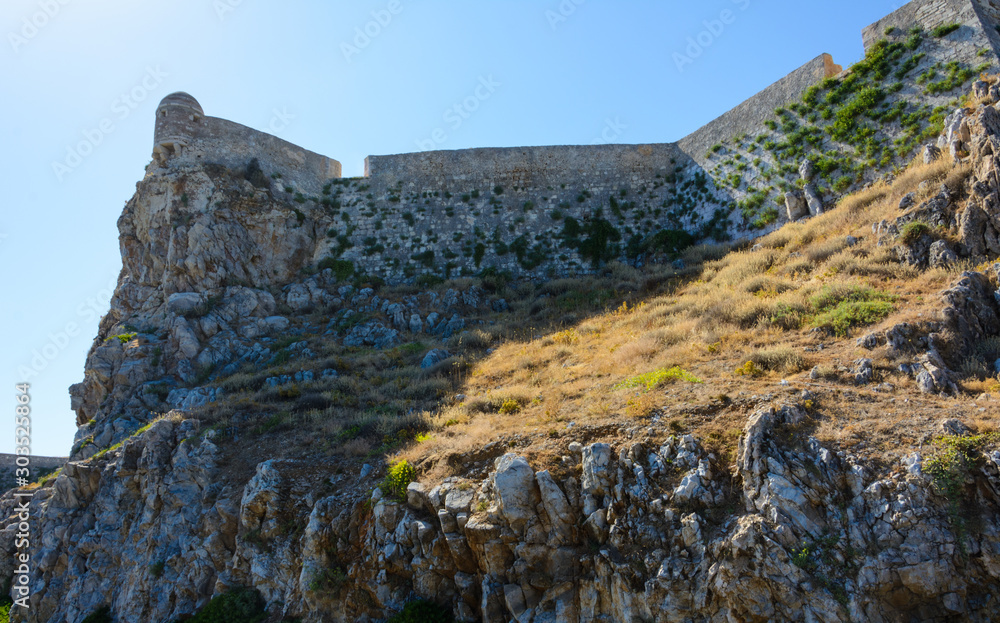 the watchtower and walls of the Fortezza fortress rise on the rock. Greece, Crete, Rethymno