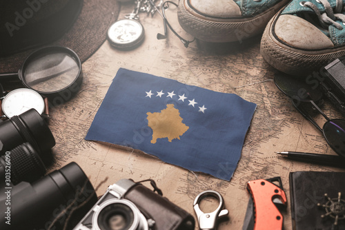 Kosovo Flag Between Traveler's Accessories on Old Vintage Map. Tourist Destination Concept.