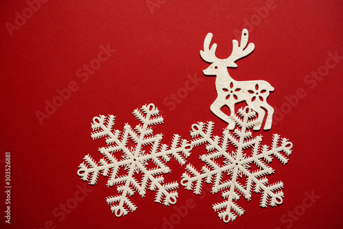 Christmas decoration with white reindeer on red background.