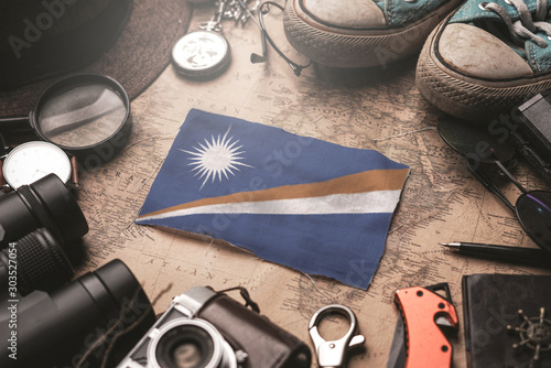 Marshall Islands Flag Between Traveler's Accessories on Old Vintage Map. Tourist Destination Concept.