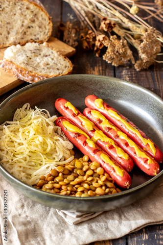 Grilled sausages with lentils. German cuisine. Beer.