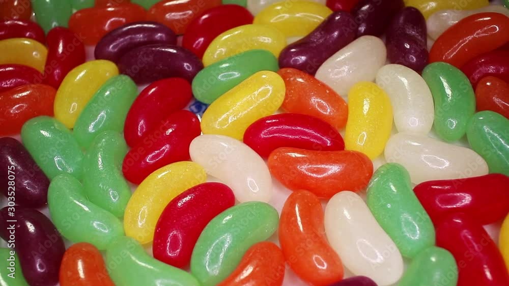 Jelly beans Jelly bean colorful candy texture on rotating rolling slorw motion plate Jelly beans Jelly bean colorful candy texture on rotating rolling slorw motion plate