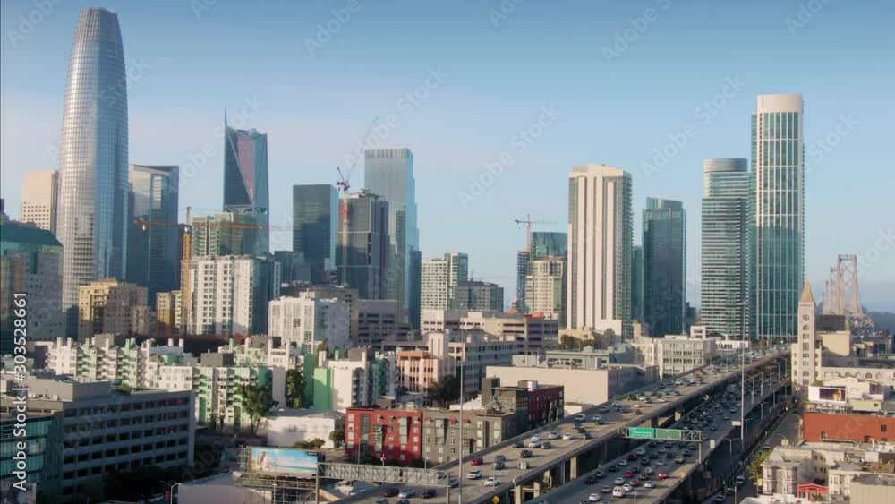 Aerial over The San Francisco City Skyline & freeway traffic at rush hour. California, USA.