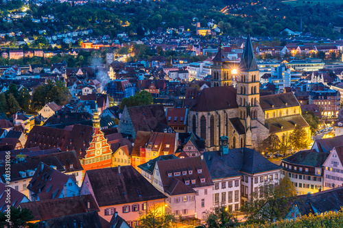 Germany, Magical lights of skyline of medieval city esslingen am neckar, aerial view above roofs, houses, st dionysius church and street by night after sunset