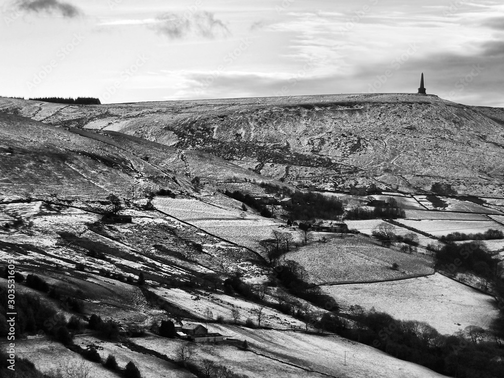 snow covered landscape with fields and moors near stoodley pike in west yorkshire.