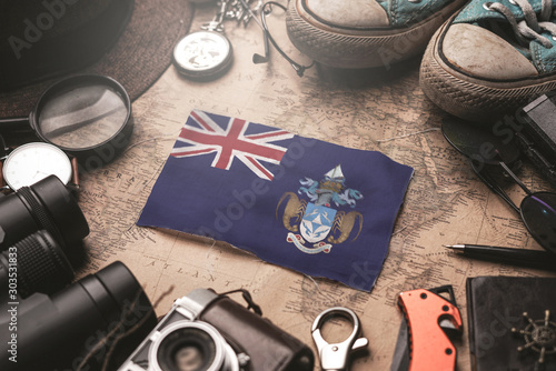 Tristan da Cunha Flag Between Traveler's Accessories on Old Vintage Map. Tourist Destination Concept. photo