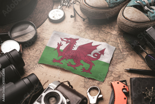 Wales Flag Between Traveler's Accessories on Old Vintage Map. Tourist Destination Concept.