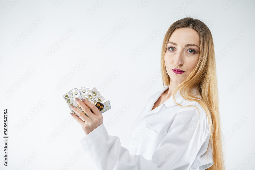 Young doctor woman in medical gown with tablets in her hand. Young doctor woman in medical gown with tablets in her hand.
