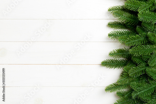 Top view of Christmas background made of fir tree branches. New year concept with copy space on wooden background