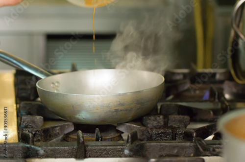 Cooking with a steel pot on the stove in the kitchen