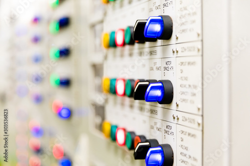 Power distributing cabinet,Electrical selector switch,button switch,Electrical switch gear at Low Voltage motor control center cabinet in power plant. blurred for background.