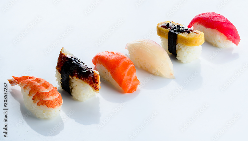 Rows of fresh Japanese nigiri on a light background Rows of fresh Japanese nigiri on a light background