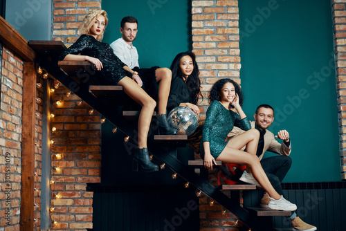 Diverse group of people posing sitting on stairs