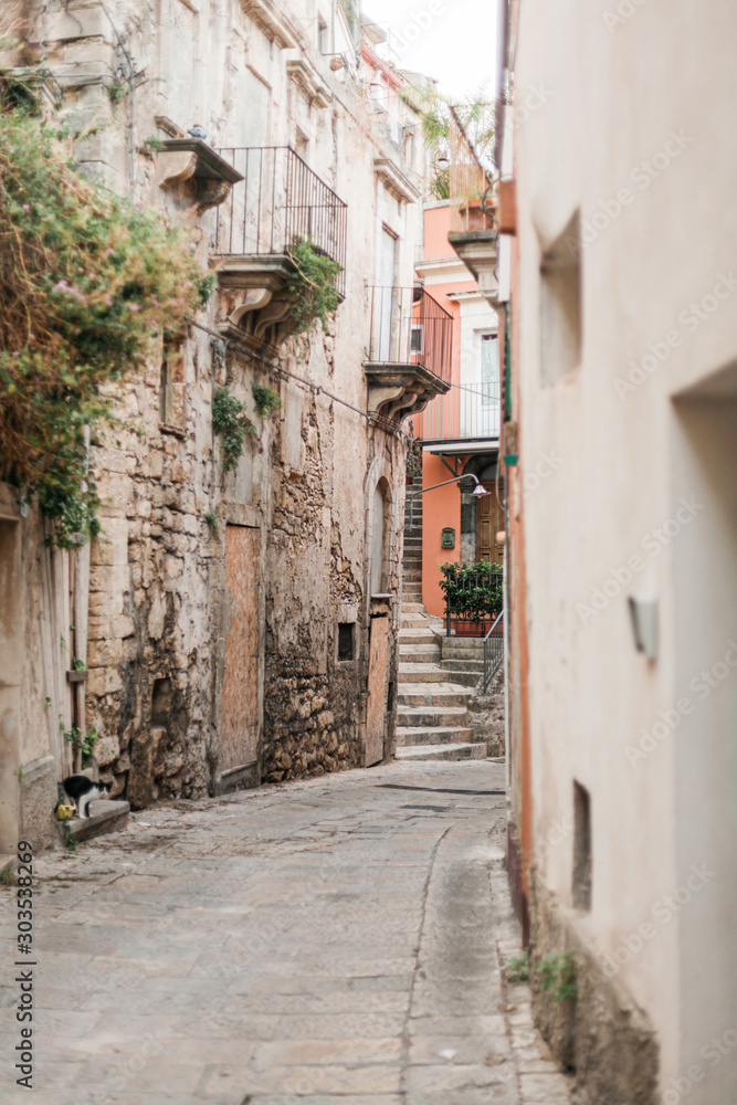 selective focus of narrow street in ragusa, italy