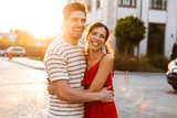 Image of joyful caucasian couple laughing and hugging