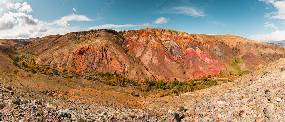 Panorama gorge in mountains. Beautiful Landscape red mountains in cloudy weather. Gorge Martian landscapes. Panorama of desert landscape on Altai, in Russia