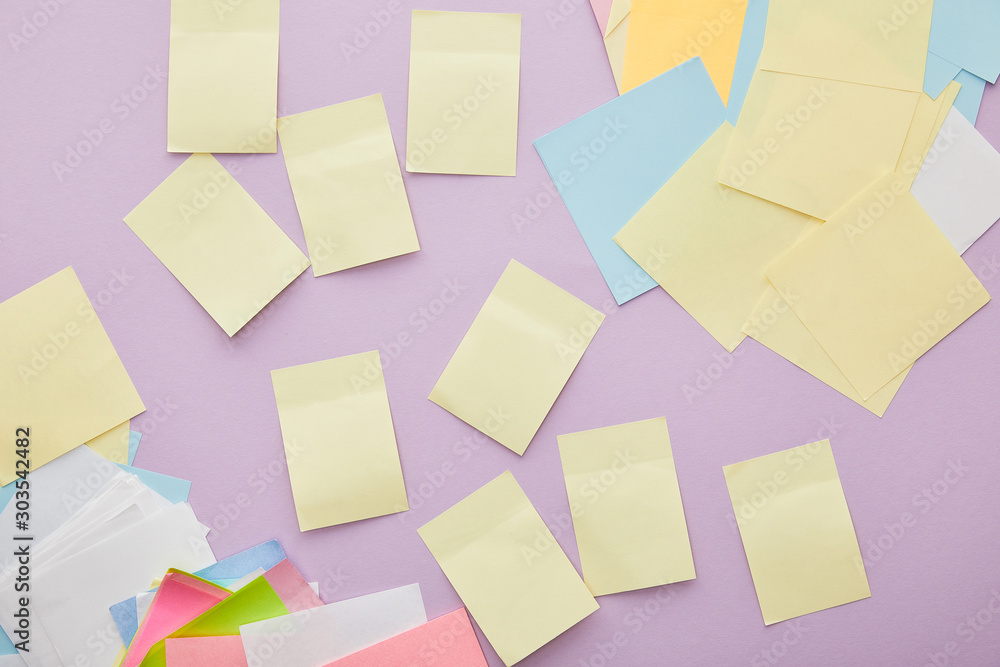 top view of colorful sticky notes isolated on purple top view of colorful sticky notes isolated on purple