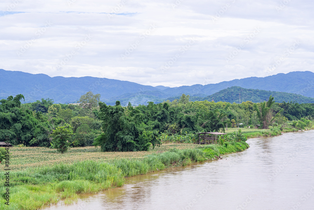 Landscape beautiful of the Rim Kok river with mountains and sky background at Chiang Rai, Thailand. Feeling Freedom and relaxing. Relaxation concept
