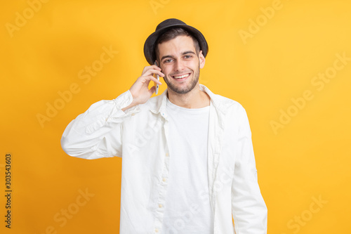 smiling young man talking on mobile phone isolated