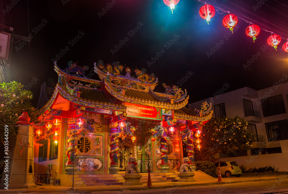 Traditional Chinese Temple decorated for The New Year with red lights on the street at night. Chao Eng Sae Shrine, Mae Nam, Koh Samui. Public place Traditional Chinese Temple decorated for The New Year with red lights on the street at night. Chao Eng Sae Shrine, Mae Nam, Koh Samui. Public place